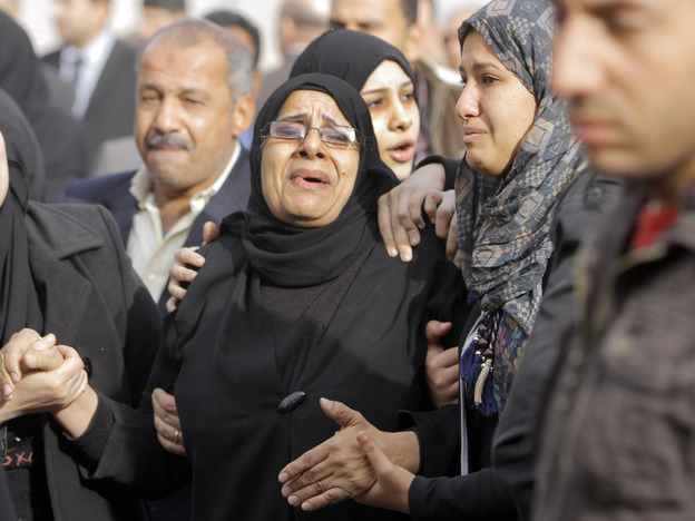 Relatives of the Egyptian policemen who were killed in Port Said grieve during their military funeral in Cairo on Sunday.