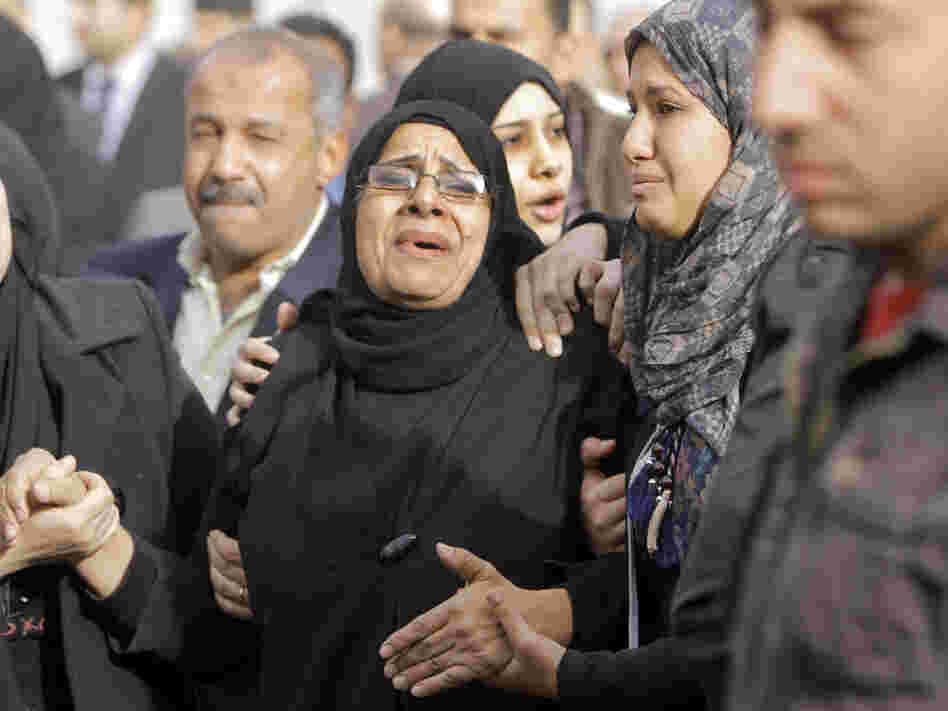 Relatives of the Egyptian policemen who were killed in Port Said grieve during their military funeral in Cairo on Sunday.