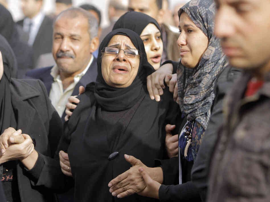 Relatives of the Egyptian policemen who were killed in Port Said grieve during their military funeral in Cairo on Sunday.