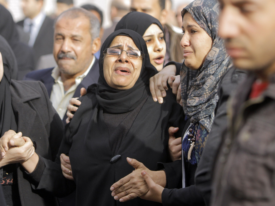 Relatives of the Egyptian policemen who were killed in Port Said grieve during their military funeral in Cairo on Sunday.
