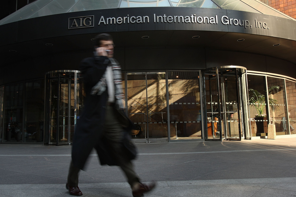 A man walks by an American International Group (AIG) building in 2009.