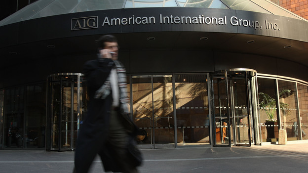 A man walks by an American International Group (AIG) building in 2009. (Getty Images)