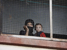 Many Syrians in the capital Damascus are feeling cooped up by the ongoing war. Here, a woman and her child who fled the fighting in their home area take refuge at a school in Damascus last September. Many Syrians in the capital Damascus are feeling cooped up by the ongoing war. Here, a woman and her child who fled the fighting in their home area take refuge at a school in Damascus last September.