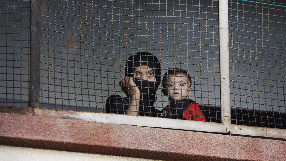 Many Syrians in the capital Damascus are feeling cooped up by the ongoing war. Here, a woman and her child who fled the fighting in their home area take refuge at a school in Damascus last September.