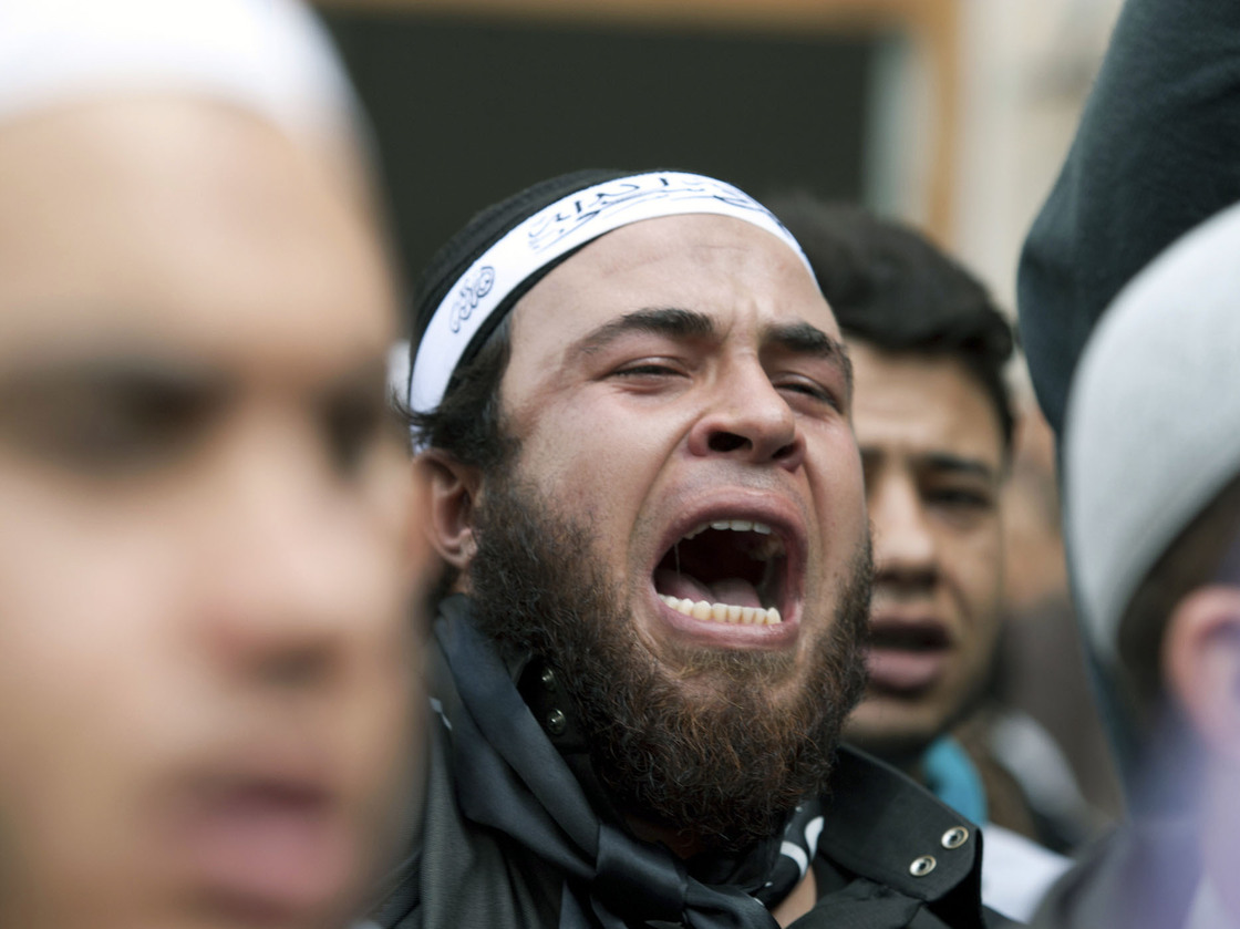 A demonstrator shouts anti-government slogans as he stands in front of the Justice Ministry in the Tunisian capital, Tunis, on Nov. 6, 2012, as part of a demonstration by radical Salafi Muslims protesting against the imprisonment of hundreds of Salafist militants.