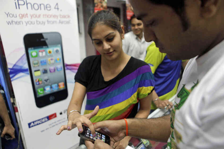 A salesperson demonstrates the Apple iPhone 4 in New Delhi, India. While mobile device use is growing rapidly in emerging markets, Apple's current product line may prove prohibitively expensive for many consumers. A salesperson demonstrates the Apple iPhone 4 in New Delhi, India. While mobile device use is growing rapidly in emerging markets, Apple's current product line may prove prohibitively expensive for many consumers.