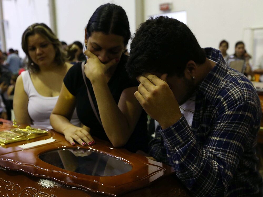Mourners at the coffin of one victim of the fire at the Kiss nightclub in southern Brazil.