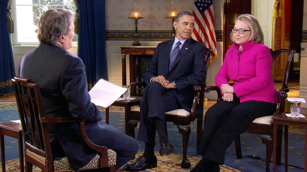 President Barack Obama, center, and Secretary of State Hillary Clinton speak with 60 Minutes correspondent Steve Kroft, left, in the Blue Room of the White House in Washington. The interview aired Sunday on CBS.
