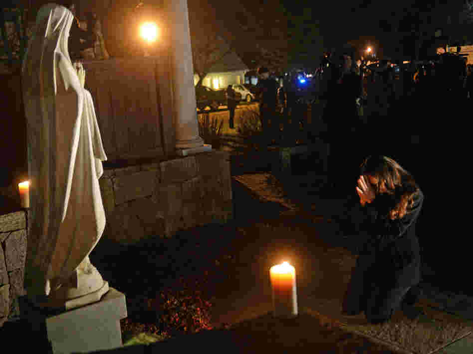 This photograph of Aline Marie praying outside St. Rose of Lima church in Newtown, Conn., has become the focus of a conversation surrounding ethics and photography on NPR's Picture Show blog.
