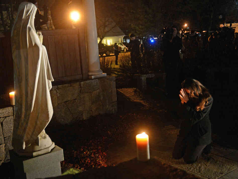 This photograph of Aline Marie praying outside St. Rose of Lima church in Newtown, Conn., has become the focus of a conversation surrounding ethics and photography on NPR's Picture Show blog.