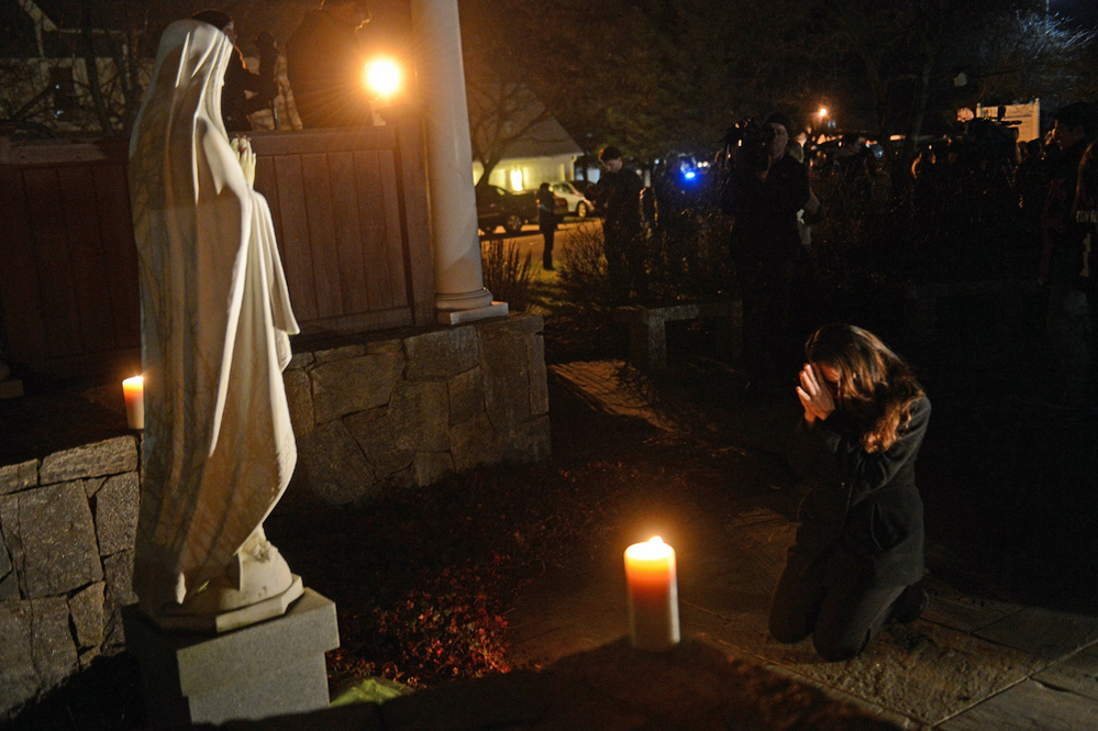 This photograph of Aline Marie praying outside St. Rose of Lima church in Newtown, Conn., has become the focus of a conversation surrounding ethics and photography.