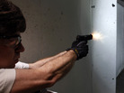 The NRA and some concealed-carry activists say the best defense against gun violence is armed "good guys." Here, a man fires his pistol at an indoor range in Aurora, Colo., last summer. The NRA and some concealed-carry activists say the best defense against gun violence is armed "good guys." Here, a man fires his pistol at an indoor range in Aurora, Colo., last summer.