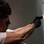 The NRA and some concealed-carry activists say the best defense against gun violence is armed "good guys." Here, a man fires his pistol at an indoor range in Aurora, Colo., last summer. The NRA and some concealed-carry activists say the best defense against gun violence is armed "good guys." Here, a man fires his pistol at an indoor range in Aurora, Colo., last summer.