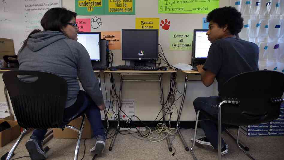Mariah Arostigue (left) and Noah Reyes, 11th-graders, chat as they work on their homework in a pre-calculus class at Segerstrom High School in Santa Ana, Calif.