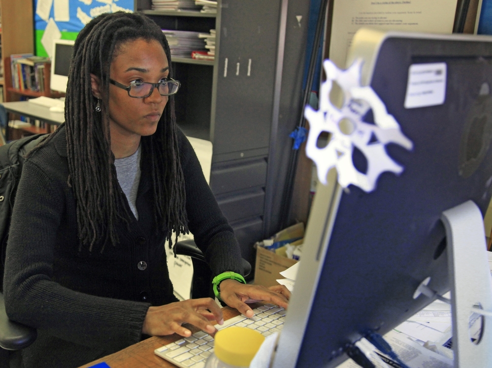 Nkomo Morris, a teacher at Brooklyn's Art and Media High School, works on her classroom computer in New York.
