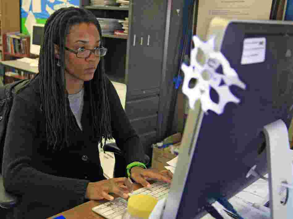 Nkomo Morris, a teacher at Brooklyn's Art and Media High School, works on her classroom computer in New York.