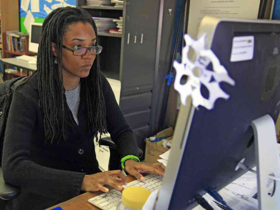 Nkomo Morris, a teacher at Brooklyn's Art and Media High School, works on her classroom computer in New York.