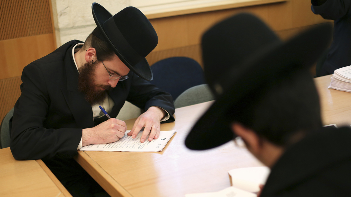 Ultra-Orthodox Jews are not required to perform military service in Israel, and the issue is subject to intense debate following the country's election last week. Here, ultra-Orthodox men sign up for alternate civilian service earlier this month.