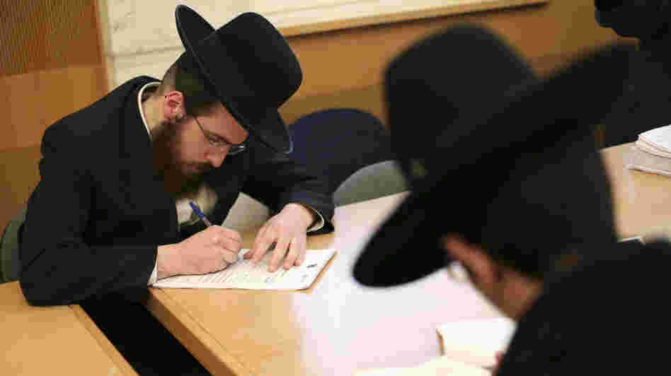 Ultra-Orthodox Jews are not required to perform military service in Israel, and the issue is subject to intense debate following the country's election last week. Here, ultra-Orthodox men sign up for alternate civilian service earlier this month.