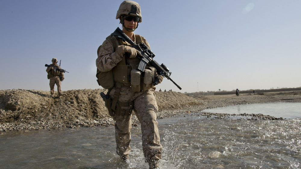 U.S. troops in Afghanistan appear to have mixed feelings about the decision lifting the ban on women in combat positions. Some women already operate in combat zones. Hospital Corpsman Shannon Crowley is shown here with her Marine Corps team in Musa Qala, Afghanistan, in November 2010.