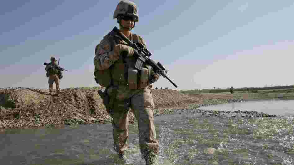 U.S. troops in Afghanistan appear to have mixed feelings about the decision lifting the ban on women in combat positions. Some women already operate in combat zones. Hospital Corpsman Shannon Crowley is shown here with her Marine Corps team in Musa Qala, Afghanistan, in November 2010.