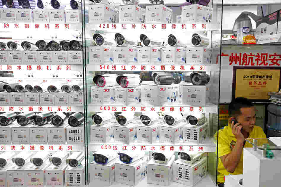 A man sells surveillance cameras at the main electronics market in Tienhe district, Guangzhou, in southern China's Guangdong province, on Aug. 8.