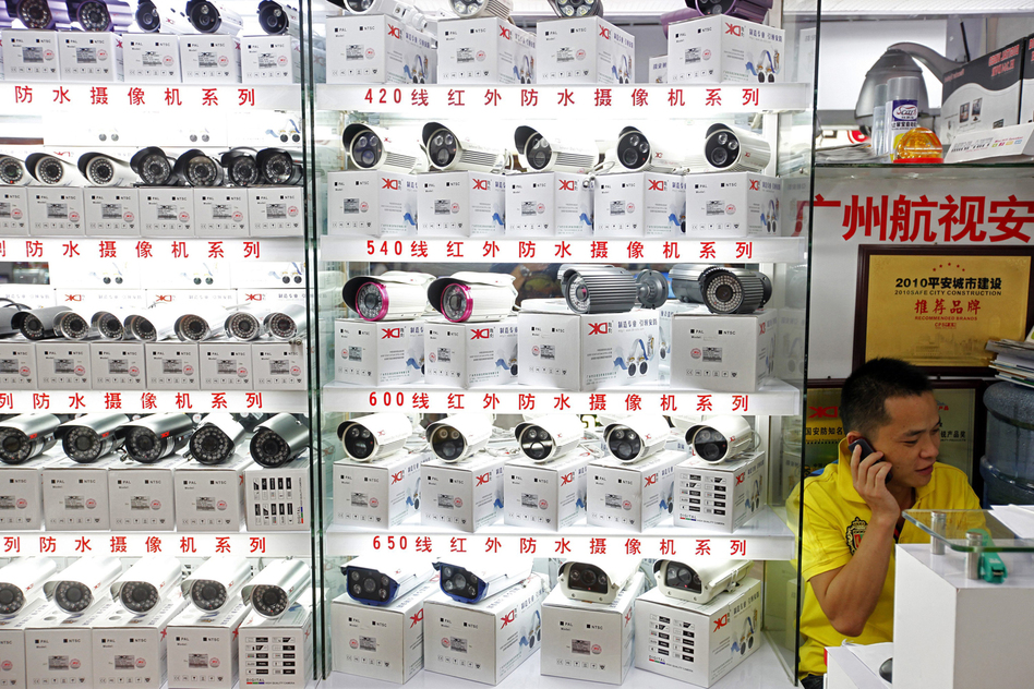 A man sells surveillance cameras at the main electronics market in Tienhe district, Guangzhou, in southern China's Guangdong province, on Aug. 8.