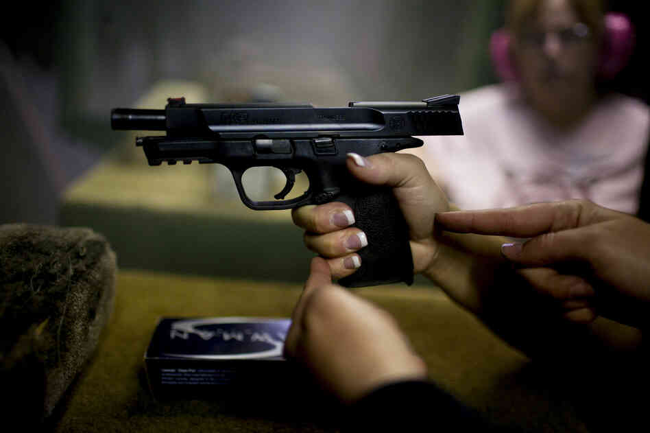 Crowder, who calls herself "The Glock Girl," gives pointers on grip to Jennifer Galle. Crowder says parents ask her to teach their kids the difference between real guns and video-game weapons. "I did a private lesson for a 9-year-old boy as his Christmas present," she says.
