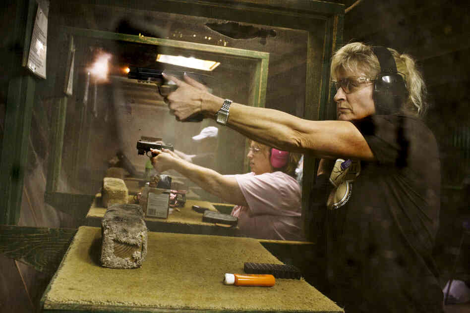 Renee Blaine fires her gun during shooting practice. Crowder says that a majority of the women who come to these events "use this as their 'girl time' away from the daily grind, the house, job, husband and kids."