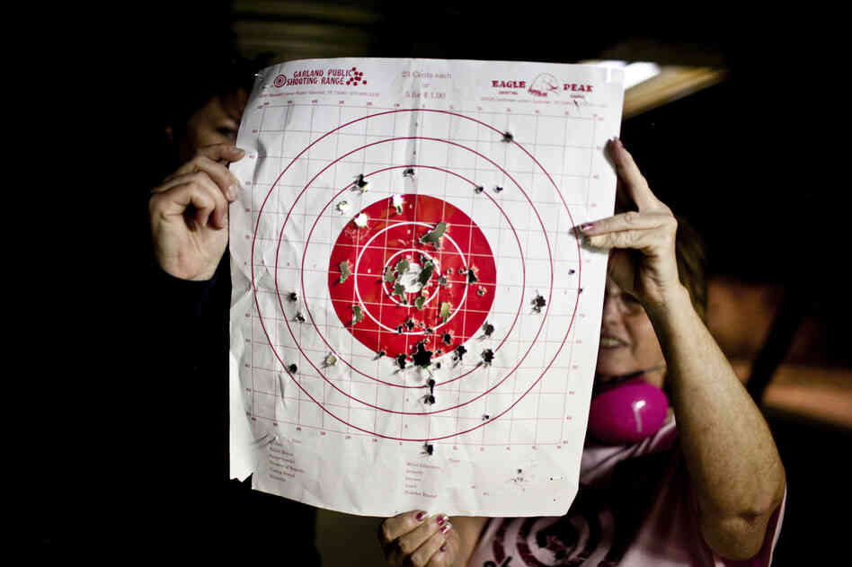 Kosarek checks her target with Crowder. According to Crowder, some women's shooting groups hire certified babysitters, and others have volunteers who take turns watching the kids, "kind of like day care at church."