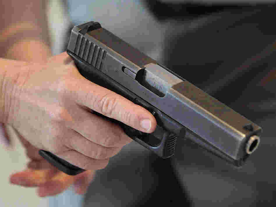 A Utah teacher is shown how to handle a handgun by instructor Clint Simon at a concealed-weapons training class Dec. 27 in West Valley City, Utah. A Utah teacher is shown how to handle a handgun by instructor Clint Simon at a concealed-weapons training class Dec. 27 in West Valley City, Utah.