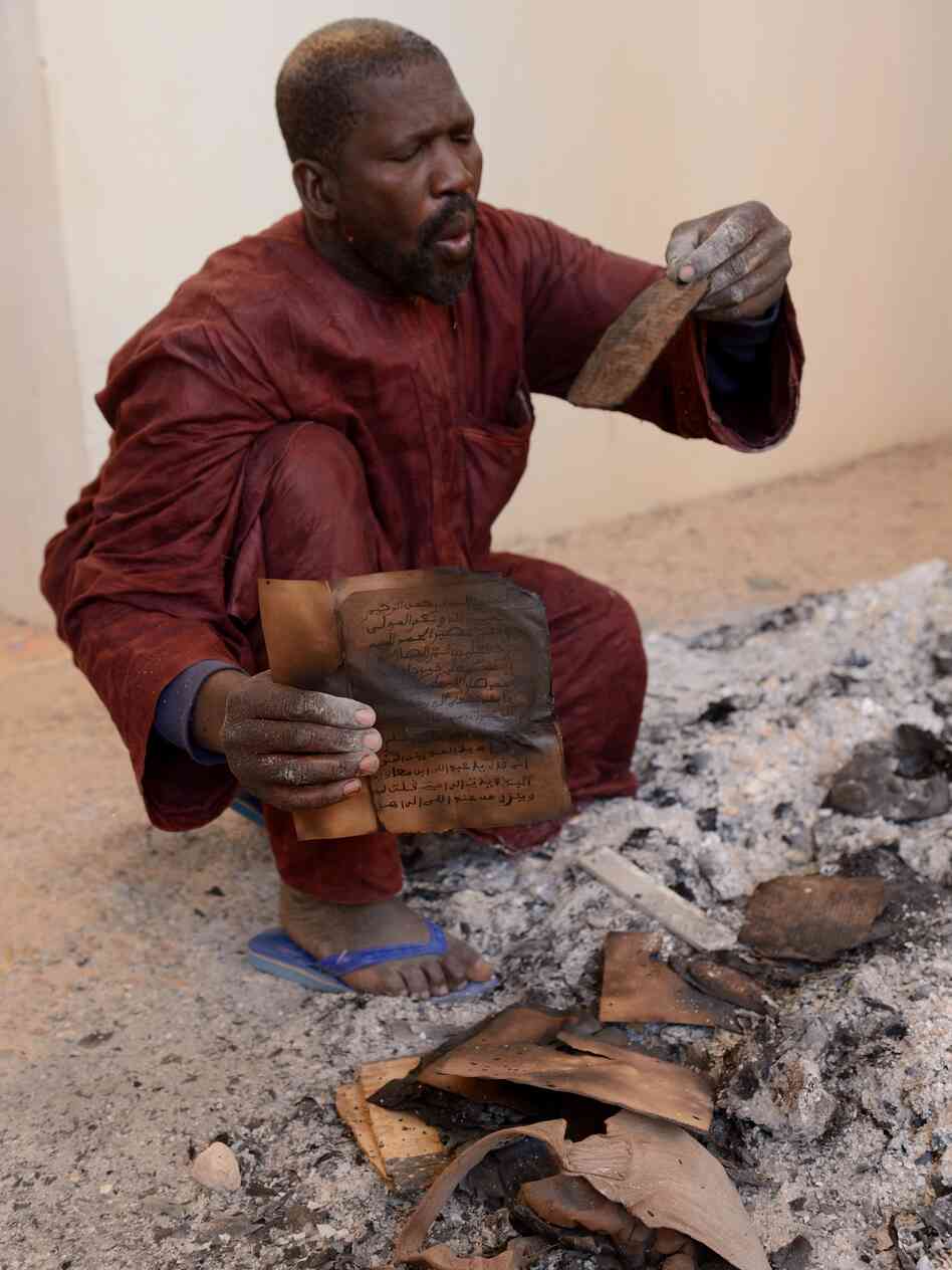 A man attempts to salvage burnt manuscripts at the Ahmed Baba Institute in Timbuktu, Mali, on Tuesday. While some of the ancient manuscripts were destroyed by Islamist radicals, reports indicate that most were hidden and therefore survived. A man attempts to salvage burnt manuscripts at the Ahmed Baba Institute in Timbuktu, Mali, on Tuesday. While some of the ancient manuscripts were destroyed by Islamist radicals, reports indicate that most were hidden and therefore survived.