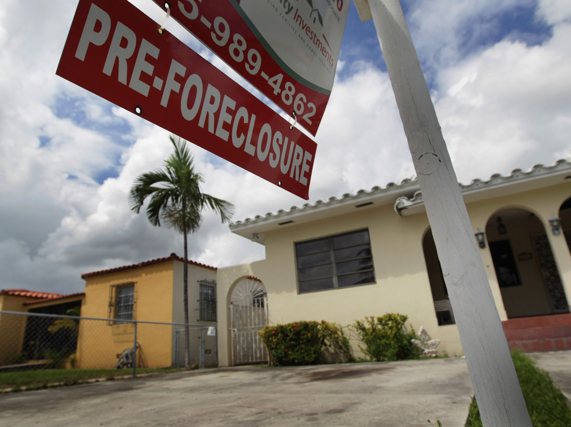 A sign hangs outside a house in Miami in 2010. Currently, Florida's foreclosure legal process can take a couple of years, which critics say is hurting the housing market.