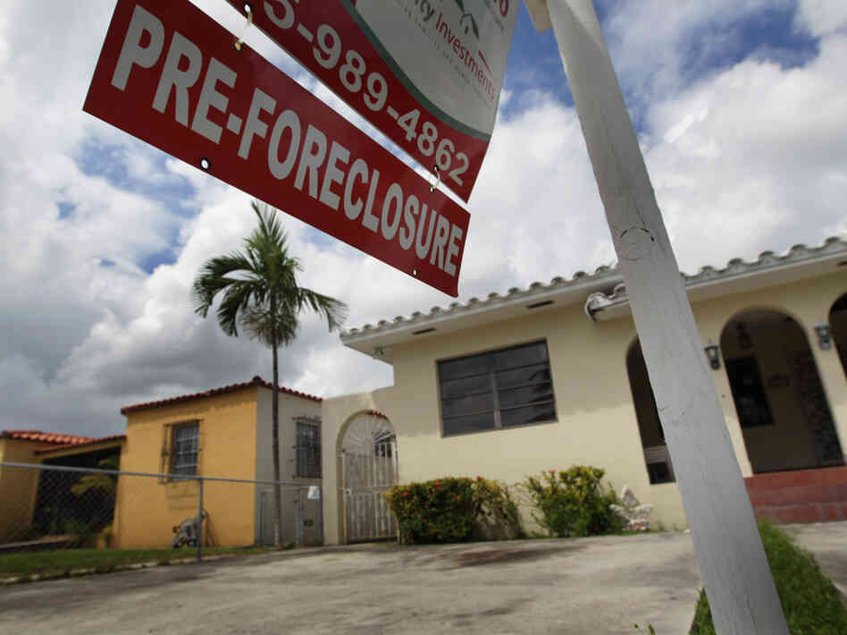 A sign hangs outside a house in Miami in 2010. Currently, Florida's foreclosure legal process can take a couple of years, which critics say is hurting the housing market.