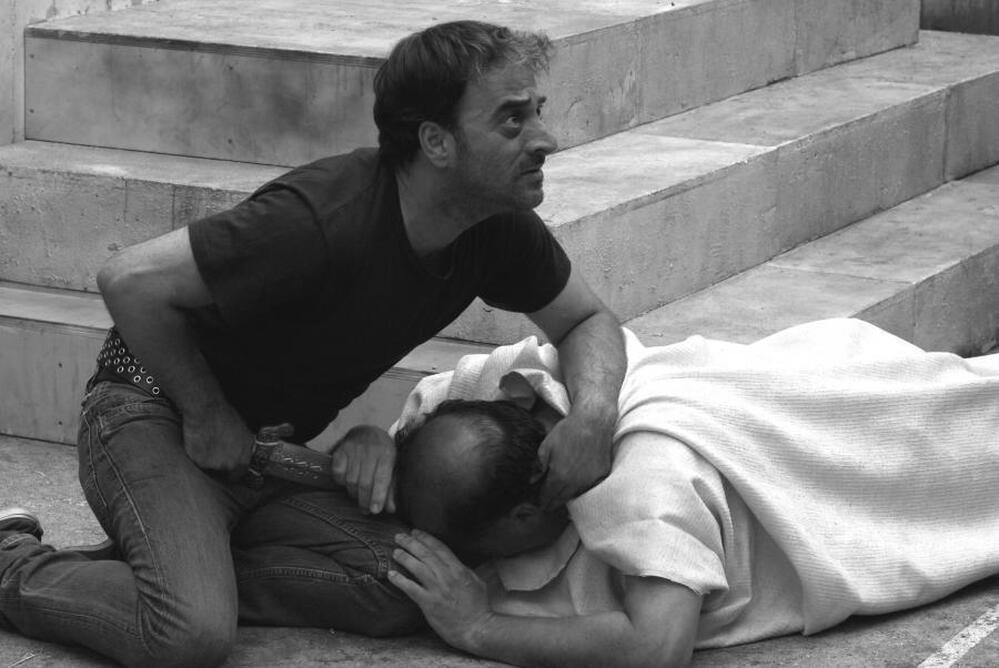 Brutus (Salvatore Striano) delivers the final blow to the dying Caesar (Giovanni Arcuri) during a performance of Shakespeare's Julius Caesar in the film Caesar Must Die.