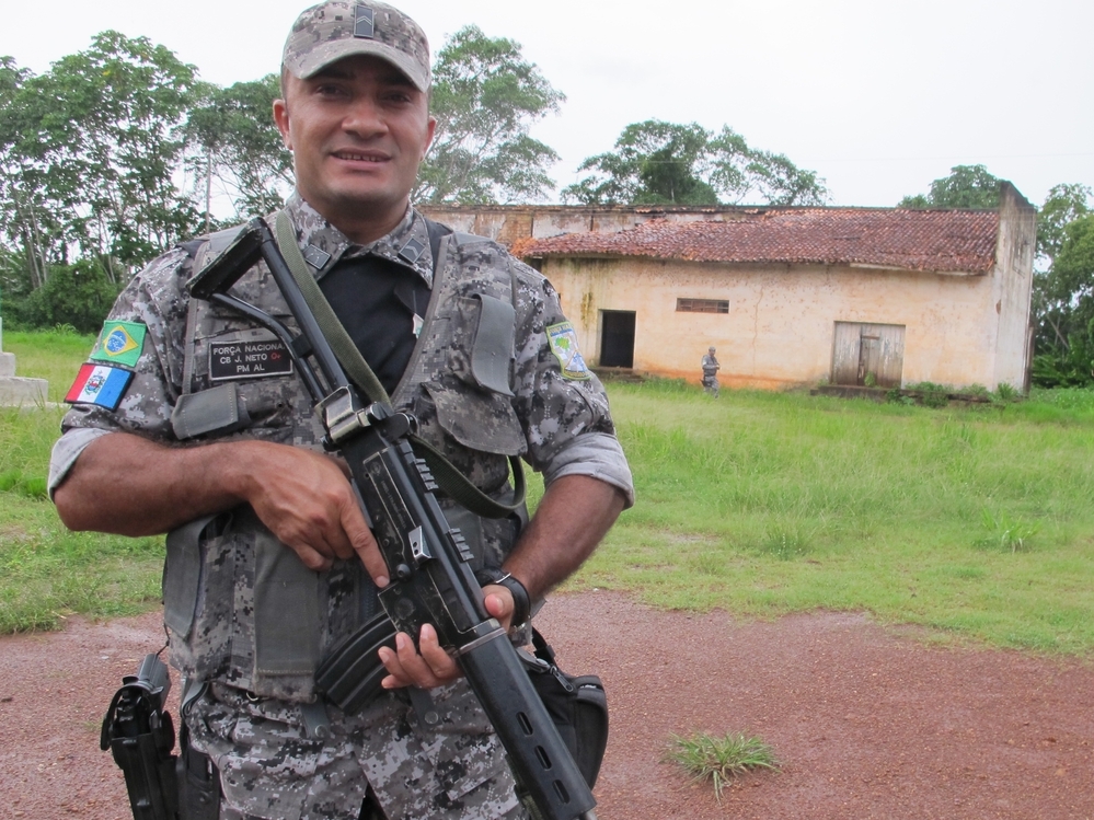 An agent of Brazil's Forca Nacional, an agency made up of military policemen, stands guard in a largely abandoned border hamlet that is used by drug traffickers to ferry cocaine from neighboring Bolivia.
