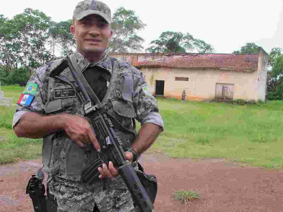 An agent of Brazil's Forca Nacional, an agency made up of military policemen, stands guard in a largely abandoned border hamlet that is used by drug traffickers to ferry cocaine from neighboring Bolivia.