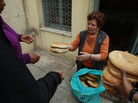Georgia Kolia, 63, has two adult children, both unemployed. She works as a volunteer distributing loaves of bread at the Agia Zonis Orthodox church soup kitchen for the poor in Athens, Greece, in April 2012. Georgia Kolia, 63, has two adult children, both unemployed. She works as a volunteer distributing loaves of bread at the Agia Zonis Orthodox church soup kitchen for the poor in Athens, Greece, in April 2012.
