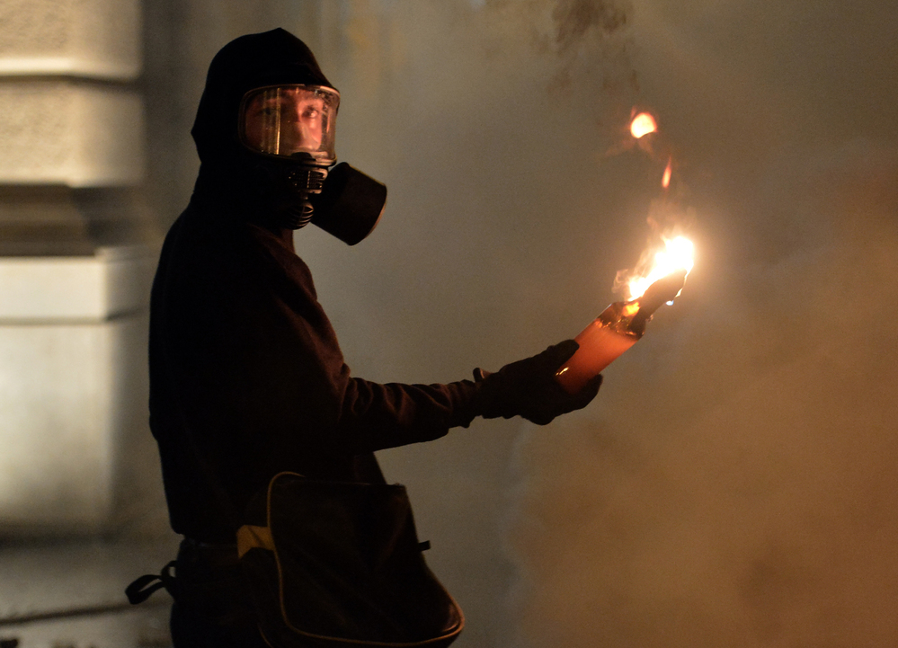 A protester holds a petrol bomb during clashes with riot police after a demonstration against new austerity measures outside the parliament in Athens, Greece, on Nov. 7.