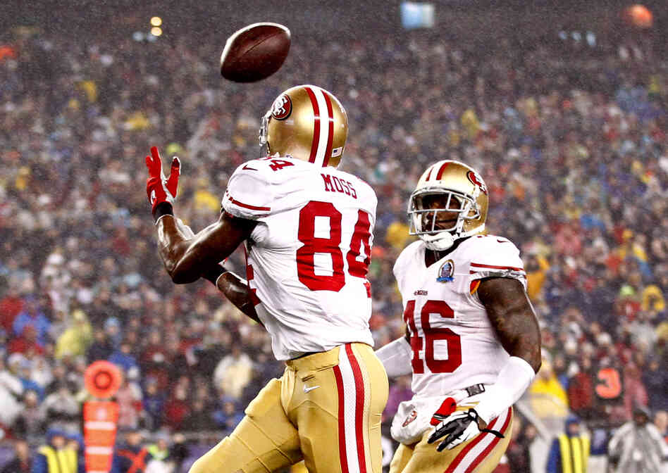 Randy Moss of the 49ers glides down the field, under an arcing football, on his way to a touchdown against the Patriots on December 16, 2012.