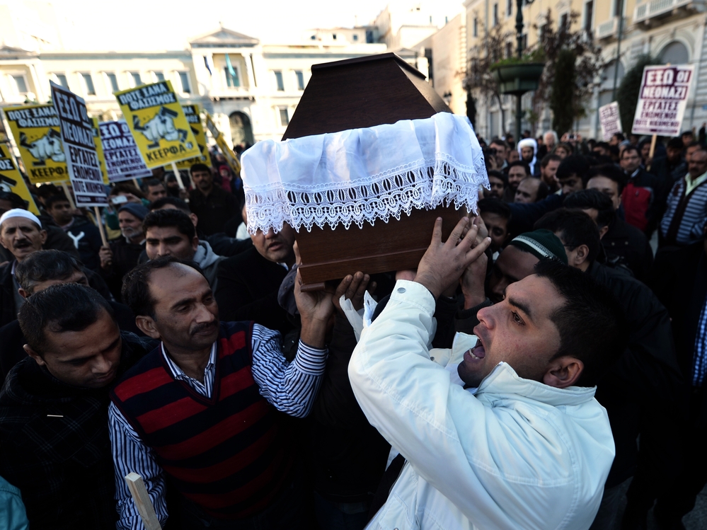 Members of the Pakistani community in Athens carry the coffin of Shehzad Luqman, the victim of what appears to have been a racist attack, on Jan. 19. It's the latest in a wave of violence associated with the right-wing, anti-immigrant Golden Dawn party.