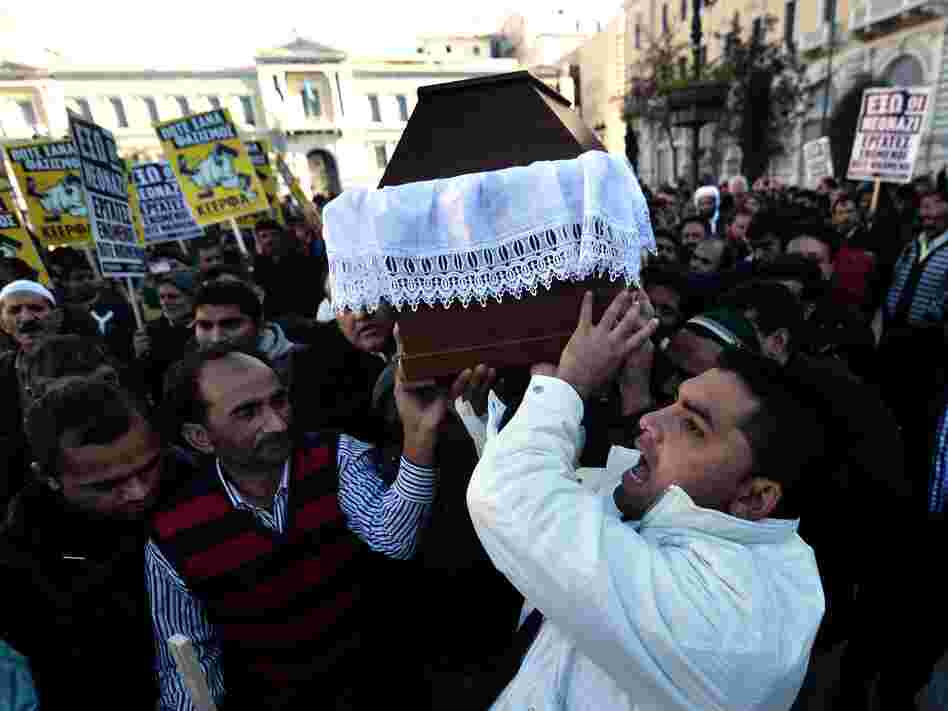 Members of the Pakistani community in Athens carry the coffin of Shehzad Luqman, the victim of what appears to have been a racist attack, on Jan. 19. It's the latest in a wave of violence associated with the right-wing, anti-immigrant Golden Dawn party.