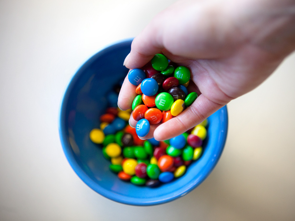 When times are tough, that prehistoric urge to splurge on high-calorie treats like M&Ms still kicks in.