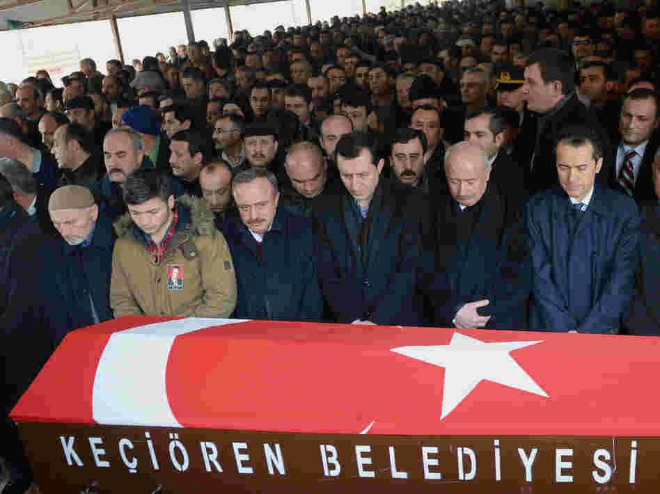 Mourners gather in Ankara on Saturday by the coffin of Mustafa Akarsu, who was killed in the attack on the U.S. Embassy in Turkey's capital on Friday.
