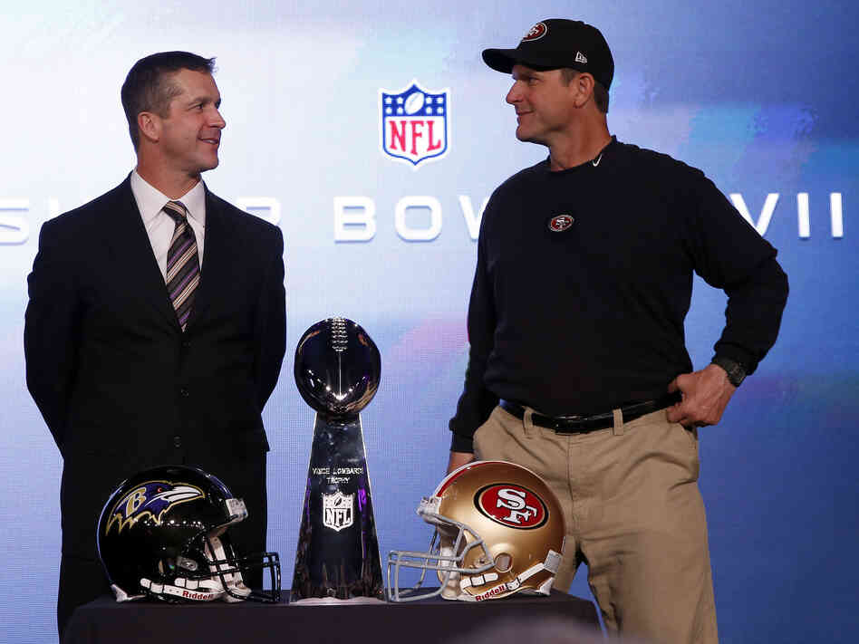 San Francisco 49ers head coach Jim Harbaugh (right) and his brother, Baltimore Ravens head coach John Harbaugh, with the Vince Lombardi Trophy on Friday.