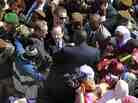 French President Francois Hollande is surrounded by well-wishers on his short visit to Timbuktu, Mali, on Saturday.