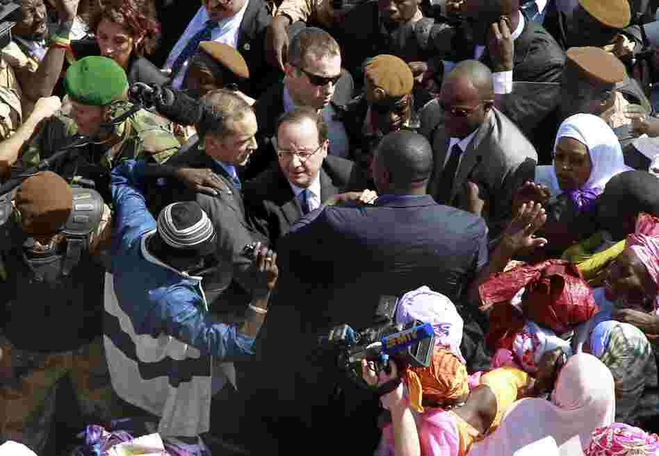 French President Francois Hollande is surrounded by well-wishers on his short visit to Timbuktu, Mali, on Saturday.