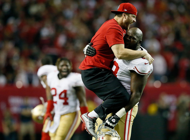 Practice squad player Nate Stupar and guard Leonard Davis of the San Francisco 49ers celebrate during the NFC Championship game on January 20.