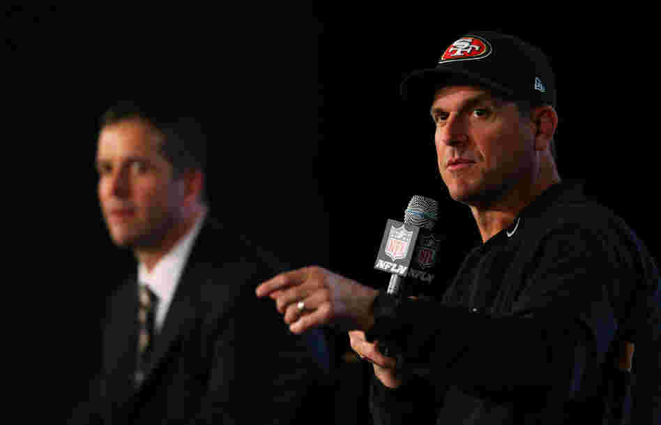 Head coach John Harbaugh (Suit-Wearing Brother) of the Baltimore Ravens and Head coach Jim Harbaugh (Hat-Wearing Brother) of the San Francisco 49ers speak to the media on Feb. 1. Head coach John Harbaugh (Suit-Wearing Brother) of the Baltimore Ravens and Head coach Jim Harbaugh (Hat-Wearing Brother) of the San Francisco 49ers speak to the media on Feb. 1.