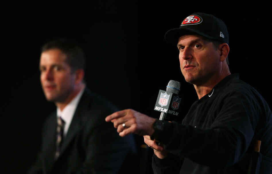 Head coach John Harbaugh (Suit-Wearing Brother) of the Baltimore Ravens and Head coach Jim Harbaugh (Hat-Wearing Brother) of the San Francisco 49ers speak to the media on Feb. 1. Head coach John Harbaugh (Suit-Wearing Brother) of the Baltimore Ravens and Head coach Jim Harbaugh (Hat-Wearing Brother) of the San Francisco 49ers speak to the media on Feb. 1.